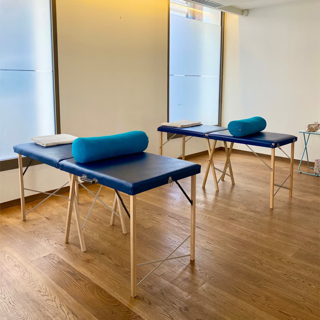 The Get Well Clinics, Paddington/Royal Oak, West London. Two blue treatment tables set up in the clinics with bolsters.