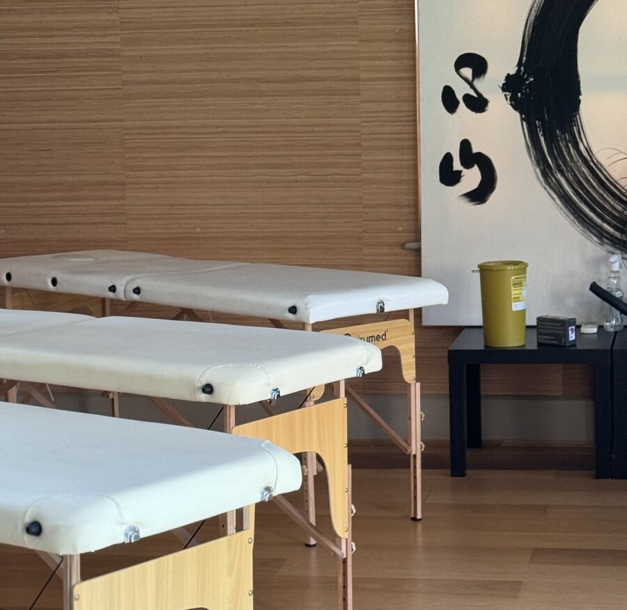 1_camberwell_900x900 The Get Well Clinics at zen yoga with three treatment tables set up for clinic and a black and white zen calligraphy painting on the wall behind the tables.