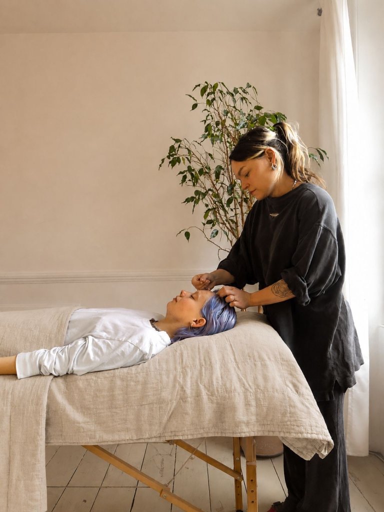 Minnie Casey treating a patient in a treatment room.